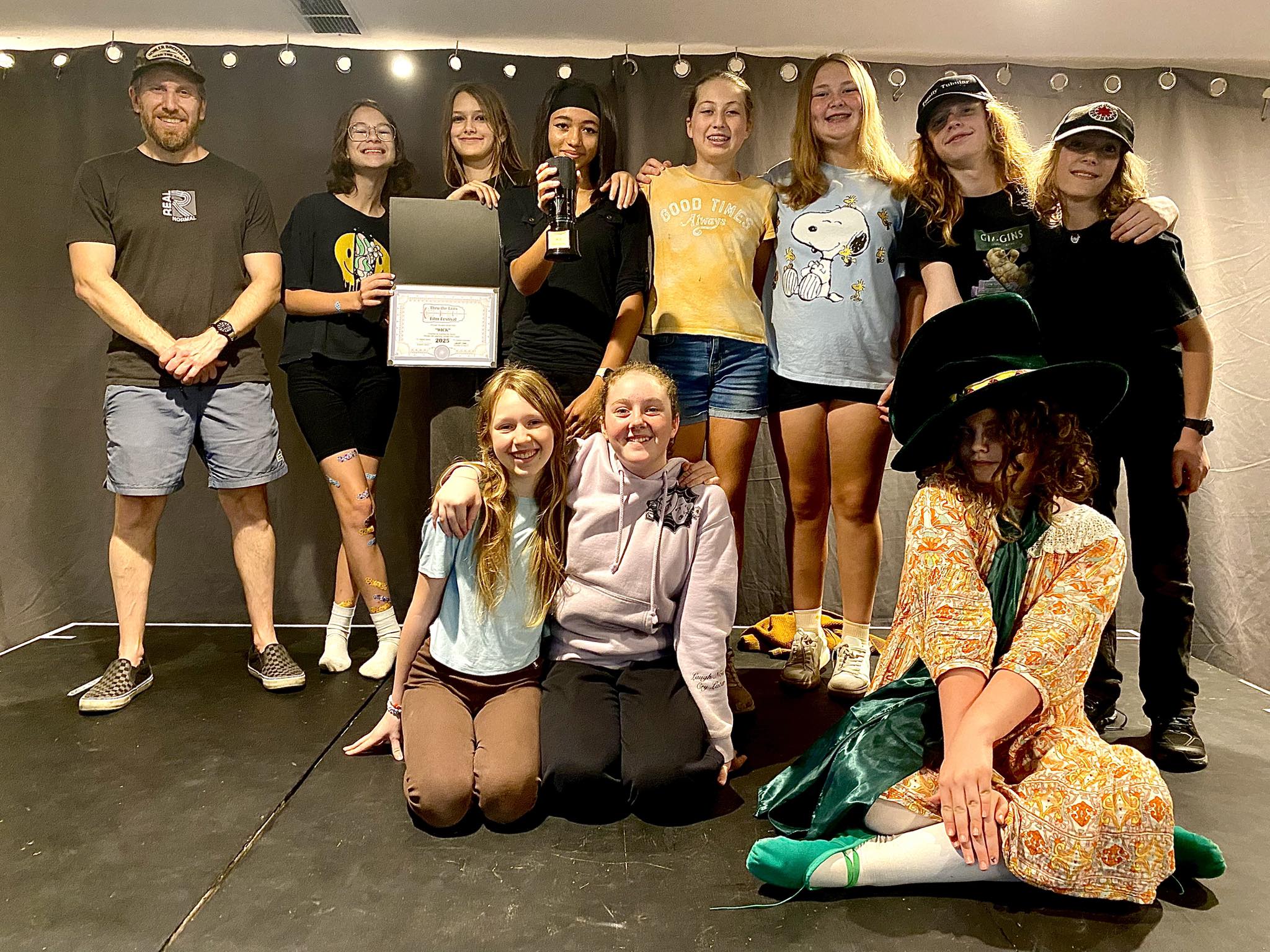 Team holding certificate and trophy